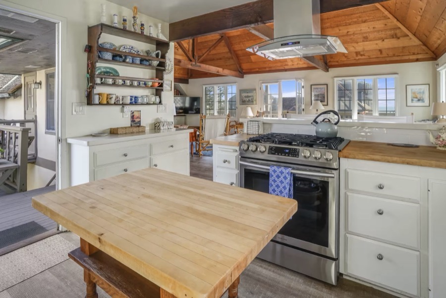 The kitchen with a gas range and morning sun